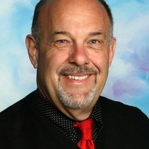 Smiling man with red tie and beard