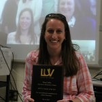 Smiling woman with award