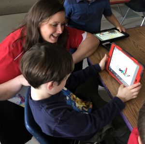 teacher working with student and tablet
