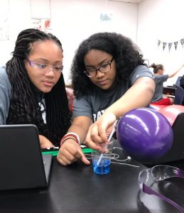 Two students working on a science experiment