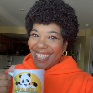 smiling woman holding a mug