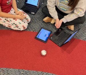 Students coding a robot with Chromebooks.